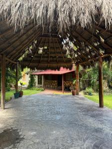 a large pavilion with a building in the background at Maïa Bacalar in Bacalar