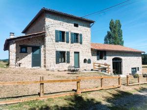 a stone cottage with a wooden fence in front of it at Gîte 12 Pers. Charme Piscine Intérieure Chauffée, Salle de Jeux - FR-1-496-346 in Saint-Priest-la-Prugne