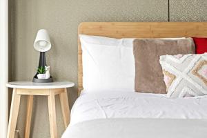 a bedroom with a bed with a lamp on a side table at Private Double Room - Centrally Located At Ryde - Shared Bathroom in Sydney