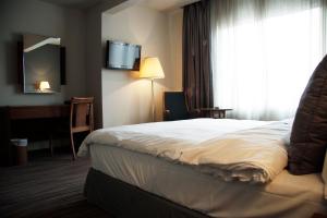 מיטה או מיטות בחדר ב-Plaza Hotel Beirut