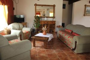 a living room with two couches and a table at El Alamo Hotel in Comandante Luis Piedra Buena