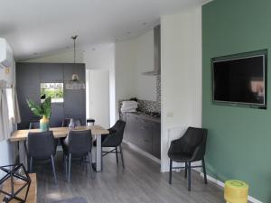a kitchen and dining room with a table and chairs at Charming Retreat for Your Escape in Bemelen