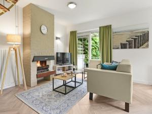a living room with a couch and a fireplace at Holiday Home by the Sea in Brouwershaven