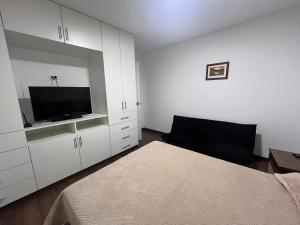 a bedroom with a bed and a flat screen tv at Departamento estreno Yanahuara in Arequipa