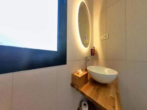 a bathroom with a white bowl sink on a wooden counter at Apartment in Puerto del Rosario near Playa Chica in Puerto del Rosario +33 photos