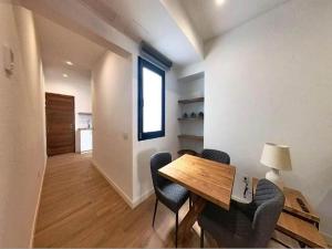 a dining room with a table and chairs and a window at Apartment in Puerto del Rosario near Playa Chica in Puerto del Rosario