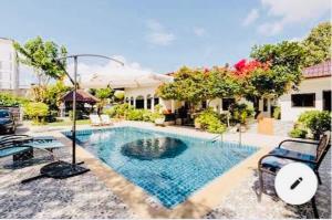 a swimming pool in the middle of a house at Green View suite with private bathroom and kitchen in Ban Phlu Yai