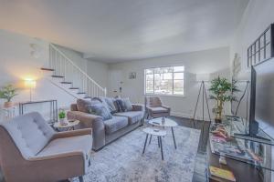 ein Wohnzimmer mit einem Sofa, Stühlen und einer Treppe in der Unterkunft 20 Minute Walk to Tiger Stadium - Near Downtown in Baton Rouge