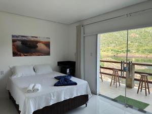 Ένα ή περισσότερα κρεβάτια σε δωμάτιο στο Suítes Lampião +9 φωτογραφίες
