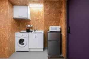 a kitchen with a washing machine and a microwave at Honeyhome in Seoul +9 photos