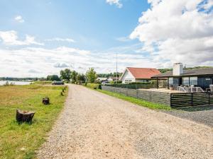 a dirt road next to a house and a building at 6 person holiday home in Sjølund-By Traum in Binderup Strand +41 photos