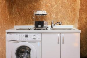 a kitchen with a washing machine and a sink at Honeyhome in Seoul