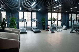 a gym with several treadmills and exercise bikes at Xi'an Eastern House in Xi'an