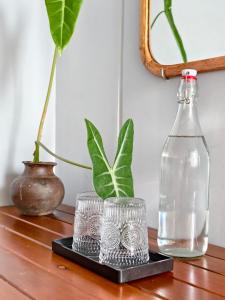 a table with two glasses and a bottle on it at Local Charm Homestay in Thôn Trường Giang +31 photos