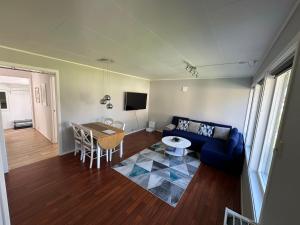 a living room with a blue couch and a table at Just a Simple House in Senjahopen +28 photos