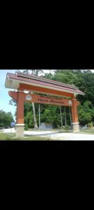 a large orange structure in a park with trees at Homestay one3nine in Kampong Batu Tiga