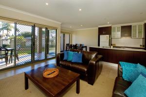 a living room with a couch and a table at 39C Cypress in Mulwala
