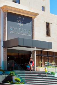 a woman and a child standing in front of a building at Odysseia Hotel Kapetanios in Limassol