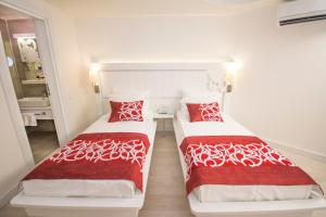 A bed or beds in a room at Laguna Beach Alya Resort & Spa