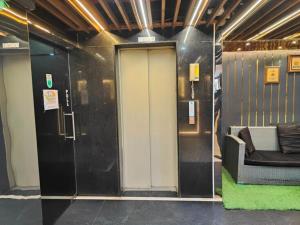 a lobby with a door and a couch in a building at The Avenue Hotel Ballygunge in Kolkata
