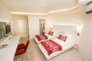 A bed or beds in a room at Laguna Beach Alya Resort & Spa