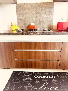a kitchen with a counter with a sink and a rug at HomeyStays 2BHK Lakeside walk in Rāi
