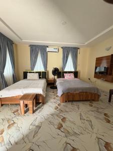 a bedroom with two beds and a large carpet at Bollington ADEX house 