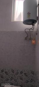 a bathroom with a window and a toilet in a room at Sanwariya Guest House in Khātu