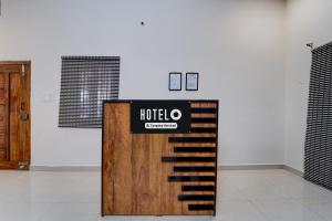 a exhibit in a room with a wooden door at Super Hotel O Central Zone Vishwanathapuram Formerly Green Nest in Coimbatore