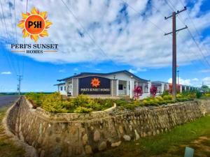 a house with a sign that reads pens sunsets houses at Peris Sunset Homes in Nadi +3 photos
