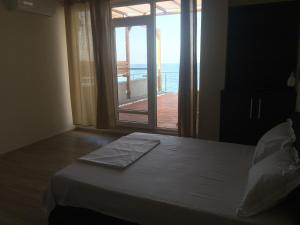 1 dormitorio con 1 cama y vistas al océano en Vila Brandusa, en Eforie Nord