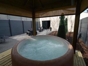 a large bath tub sitting in a yard at Home in Welkenraedt with Steam Shower in Welkenraedt