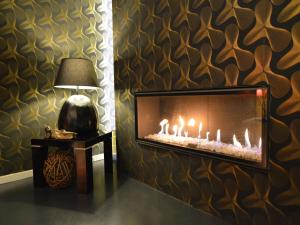 a living room with a fireplace and a lamp at Home in Welkenraedt with Steam Shower in Welkenraedt