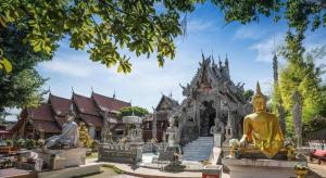 a temple with statues in front of a building at B2 Thippanate Boutique & Budget Hotel in Chiang Mai