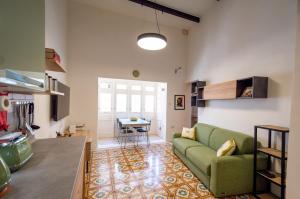 a living room with a green couch and a table at 13, Mustard in Birgu