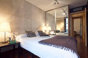 a bedroom with a large bed with a large mirror at Apartment Barcelona Rentals - Sarria Apartments Near Center in Barcelona