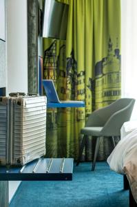 a room with a bed, a table and a chair at ibis Styles Tuebingen in Tübingen