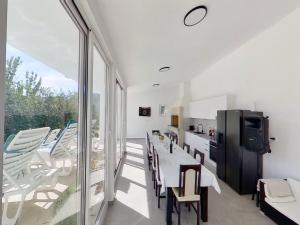 a kitchen and dining room with a table and chairs at Beautiful holiday home with private sauna in Neorić