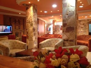 a restaurant with chairs and a table and a television at Al Rashid Hotel in Wadi Musa