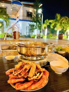 a plate of food on top of a table at Villa Sapphire in Vung Tau
