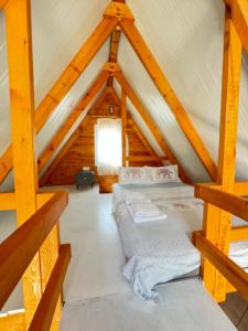a bedroom in a log cabin with two beds at Bungalow-8 in Karaburun Boyabağ Bay in Karaburun