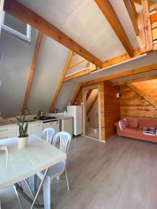 a kitchen and living room with a table and chairs at Bungalow-8 in Karaburun Boyabağ Bay in Karaburun
