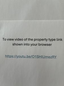 a white piece of paper with the words to view video of the property typeink at Whisper Cottage in Onetangi