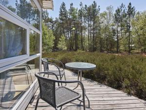a patio with a table and chairs on a porch at 4 person holiday home in Nexø in Neksø