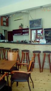 a bar with wooden tables and chairs in a restaurant at Constantinos Studios in Chania Town