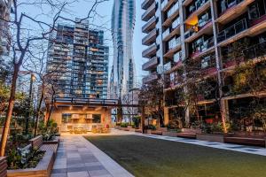 a courtyard in a city with tall buildings at City Living, Prime Location with Parking & Amenities in Melbourne