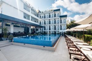a swimming pool in front of a building at Onederz Sihanoukville - 10 mins walk from the Tourism Pier in Sihanoukville