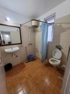 a bathroom with a toilet and a sink at Samson Vacations At Karma Royal Palms Benaulim in Benaulim
