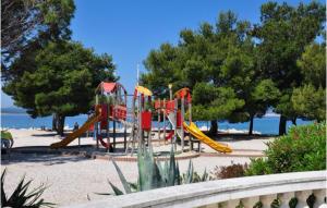 a playground in a park next to the water at Villa Una in Crikvenica