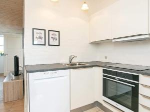 a kitchen with white cabinets and a sink at 6 person holiday home in Faaborg in Faaborg